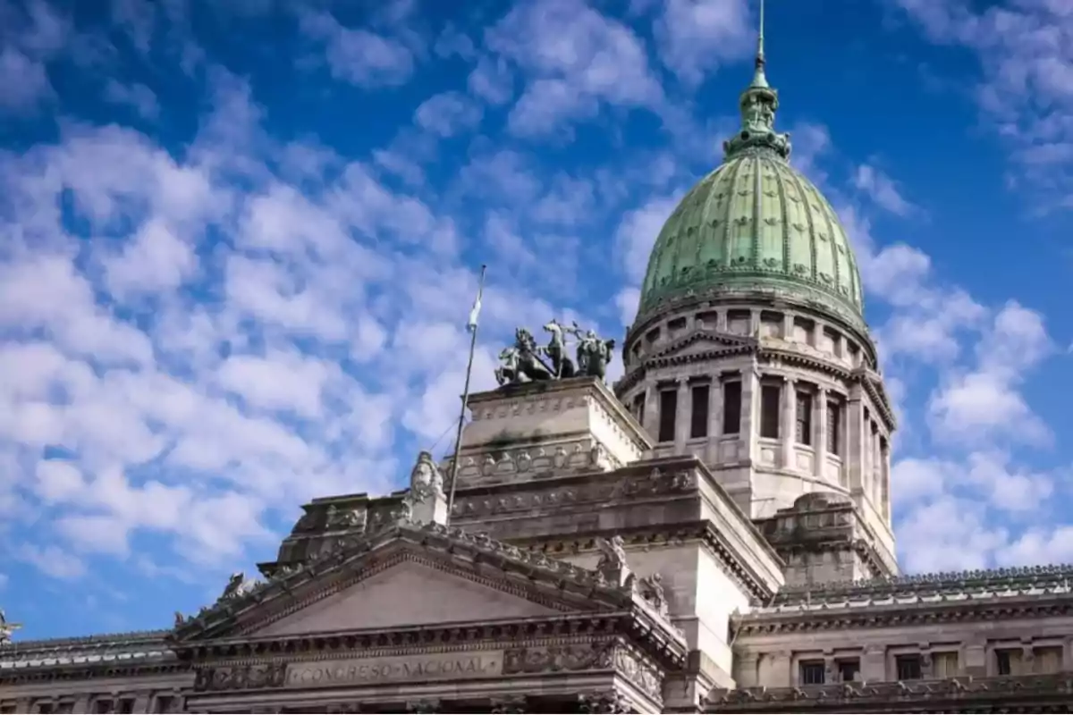 Edificio del Congreso Nacional de Argentina con cielo azul y nubes.