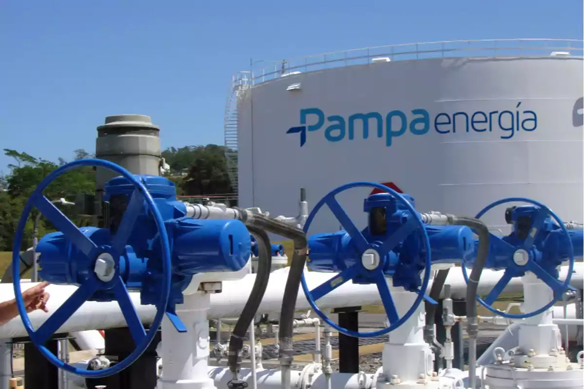 Three blue valves in an industrial facility with a white tank in the background featuring the Pampa Energía logo.