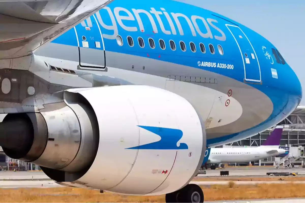 A passenger plane with the airline's logo on the fuselage and engine, parked at an airport. A passenger plane with the airline's logo on the fuselage and engine, parked at an airport.