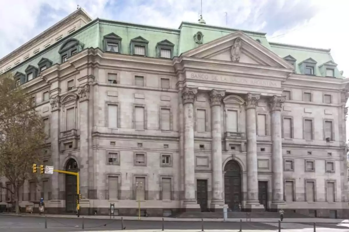 Historic building with a columned facade and green roof on an urban corner. Historic building with a columned facade and green roof on an urban corner.