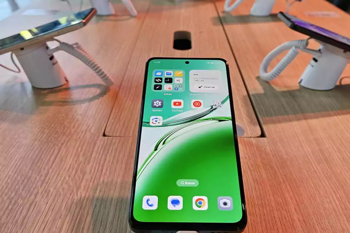 A smartphone with the screen on displaying various apps, placed on a display table in a store.