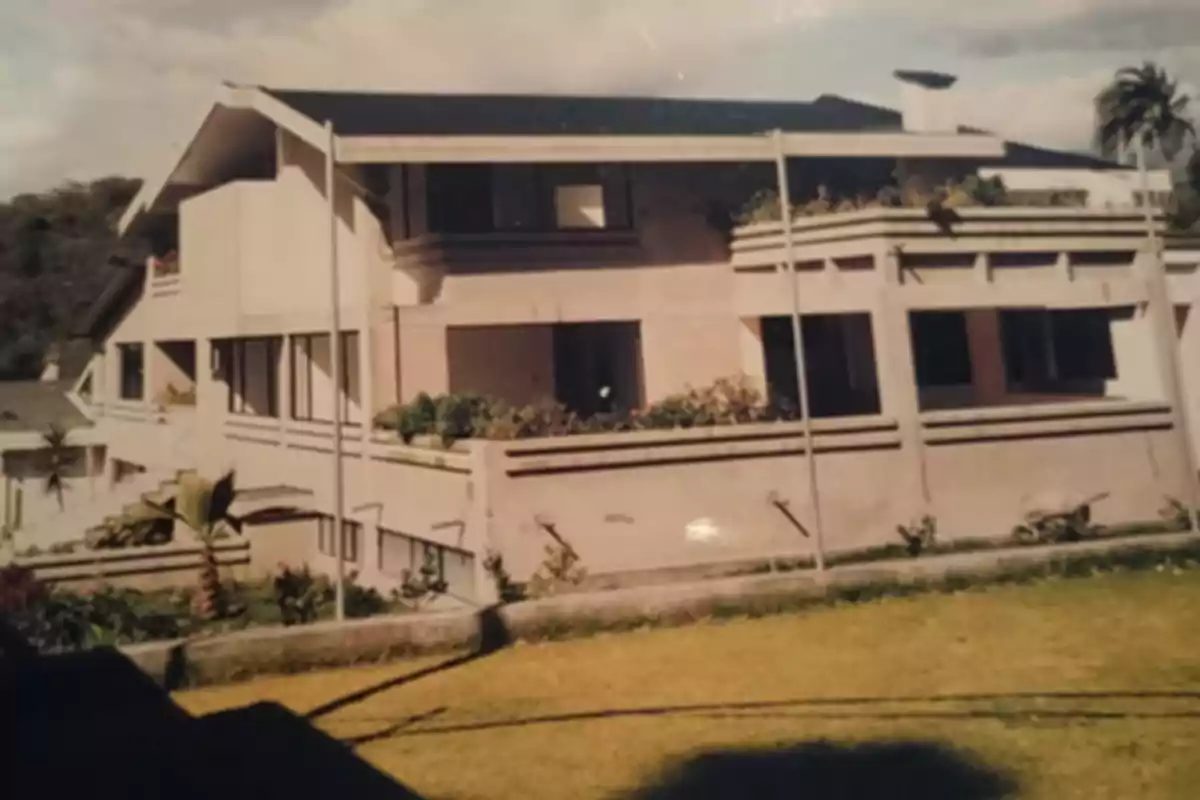 A two-story house with a modern design and a front garden.
