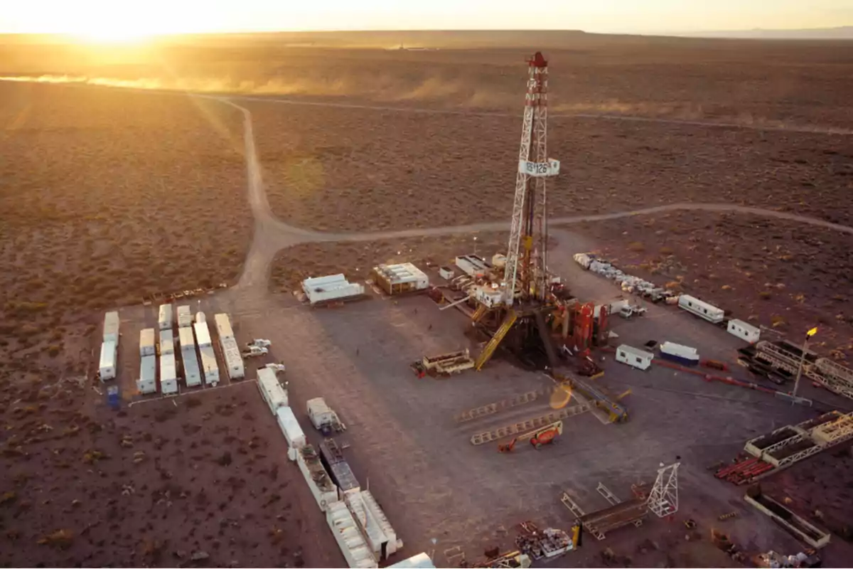 Aerial view of a drilling rig in a desert landscape at sunset. Aerial view of a drilling rig in a desert landscape at sunset.
