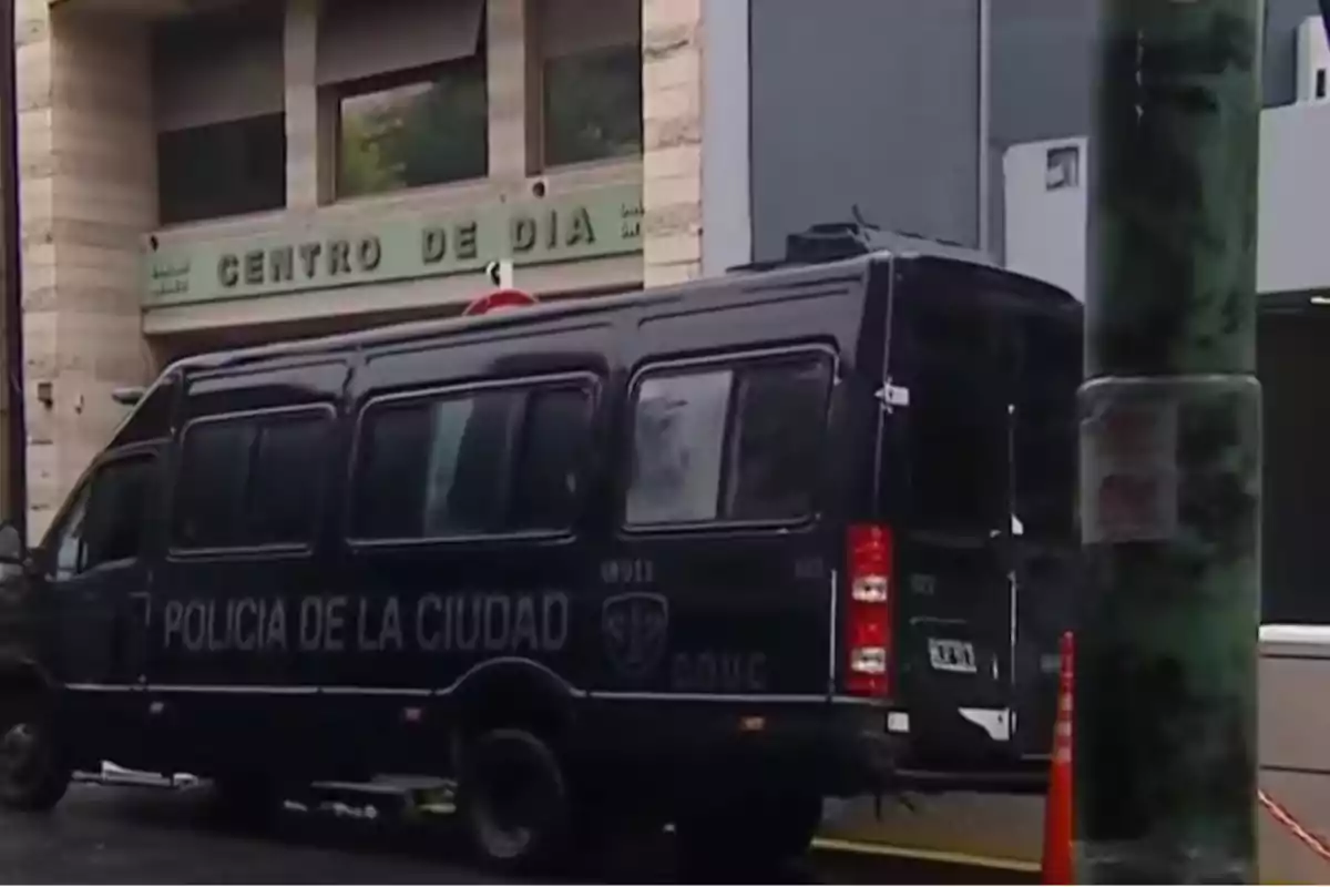 A city police pickup truck parked in front of a building with a sign that says Day Center.