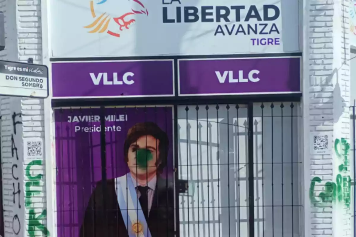 Facade of a La Libertad Avanza political office in Tigre with a sign of Javier Milei and graffiti on the wall