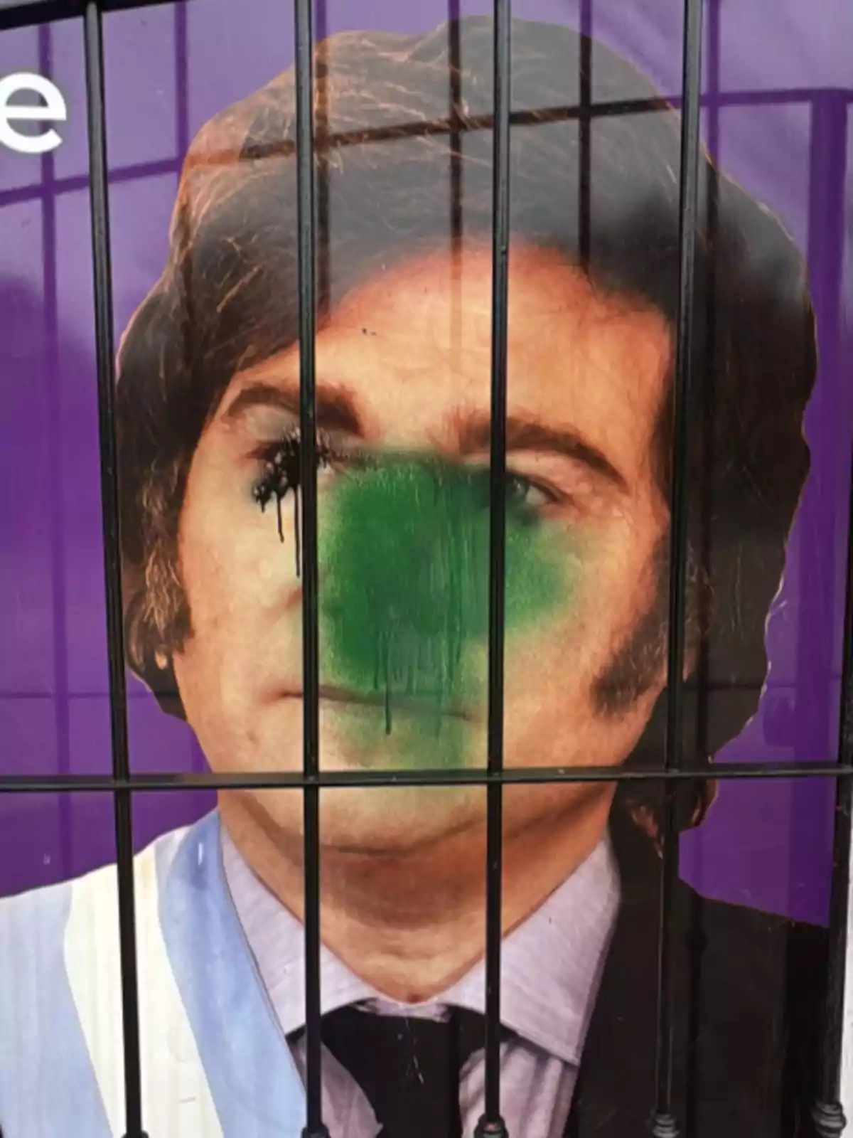 Poster of a person with their face partially covered in green and black paint behind a fence Poster of a person with their face partially covered in green and black paint behind a fence