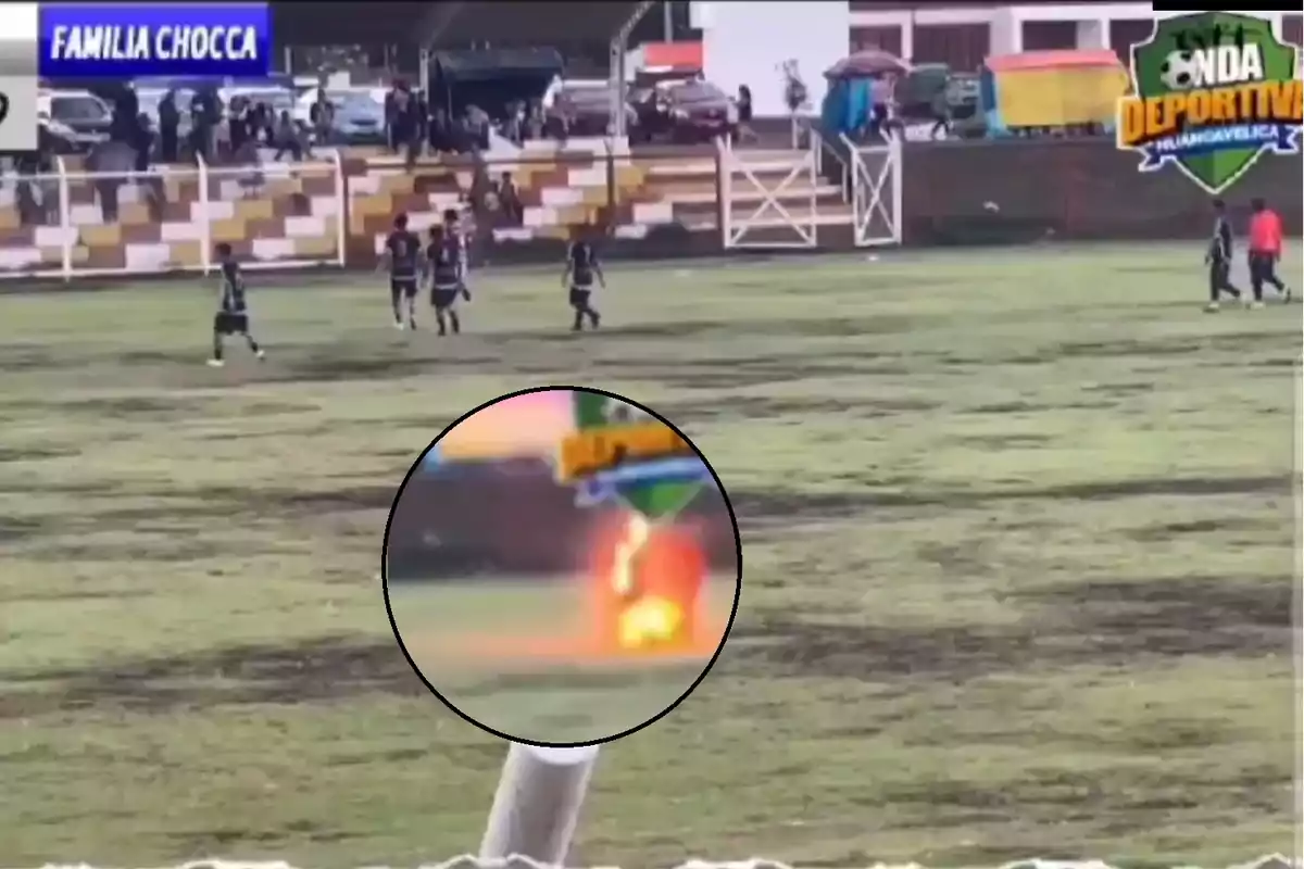 Jugadores de fútbol en un campo mientras un rayo impacta en el césped durante un partido.