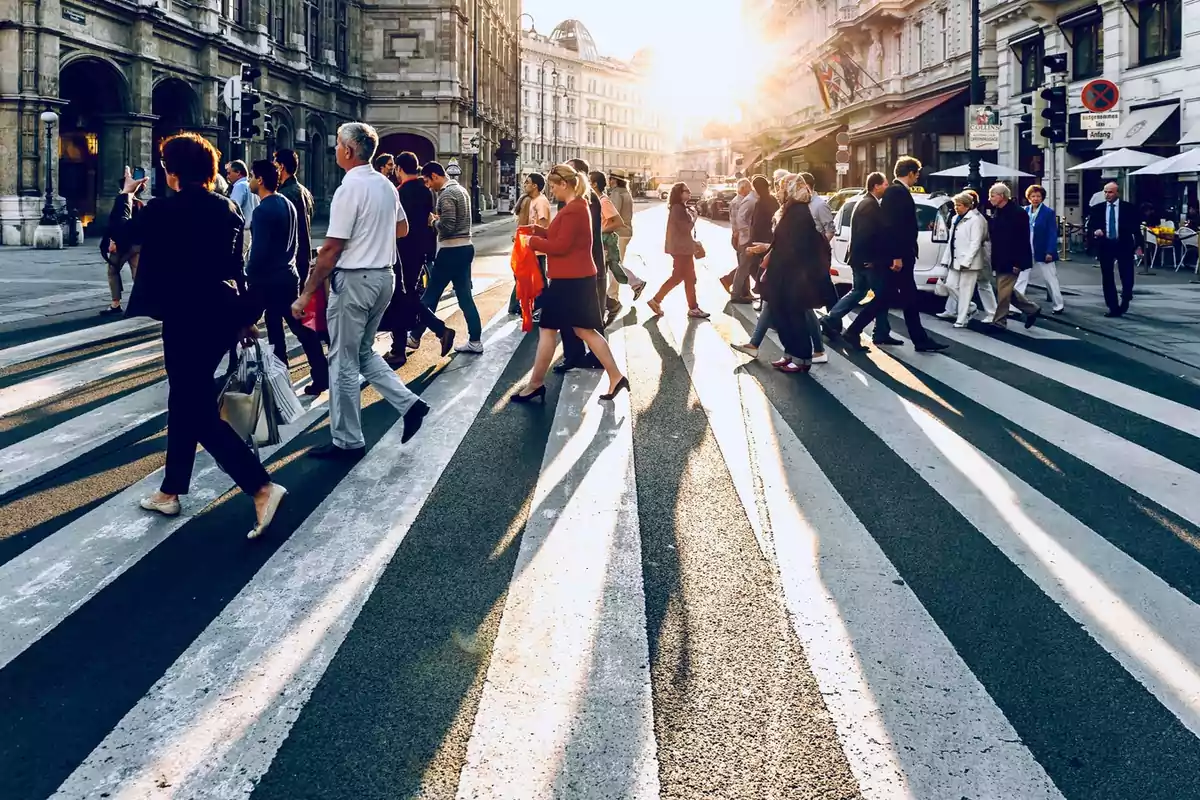 People crossing a busy street at sunset with historic buildings in the background. People crossing a busy street at sunset with historic buildings in the background.