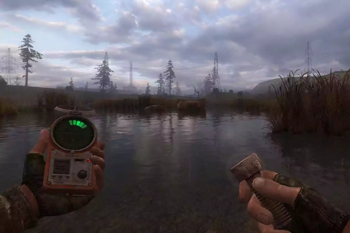 A person holds a device with a green screen and a metallic object in a natural landscape with water and trees in the background. A person holds a device with a green screen and a metallic object in a natural landscape with water and trees in the background.