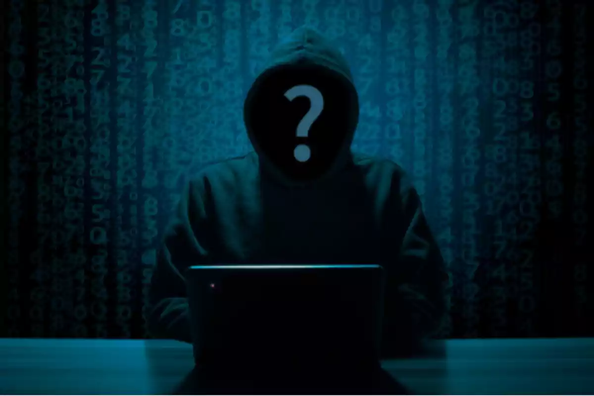 Hooded person in front of a computer with a background of numbers and a question mark on their face.