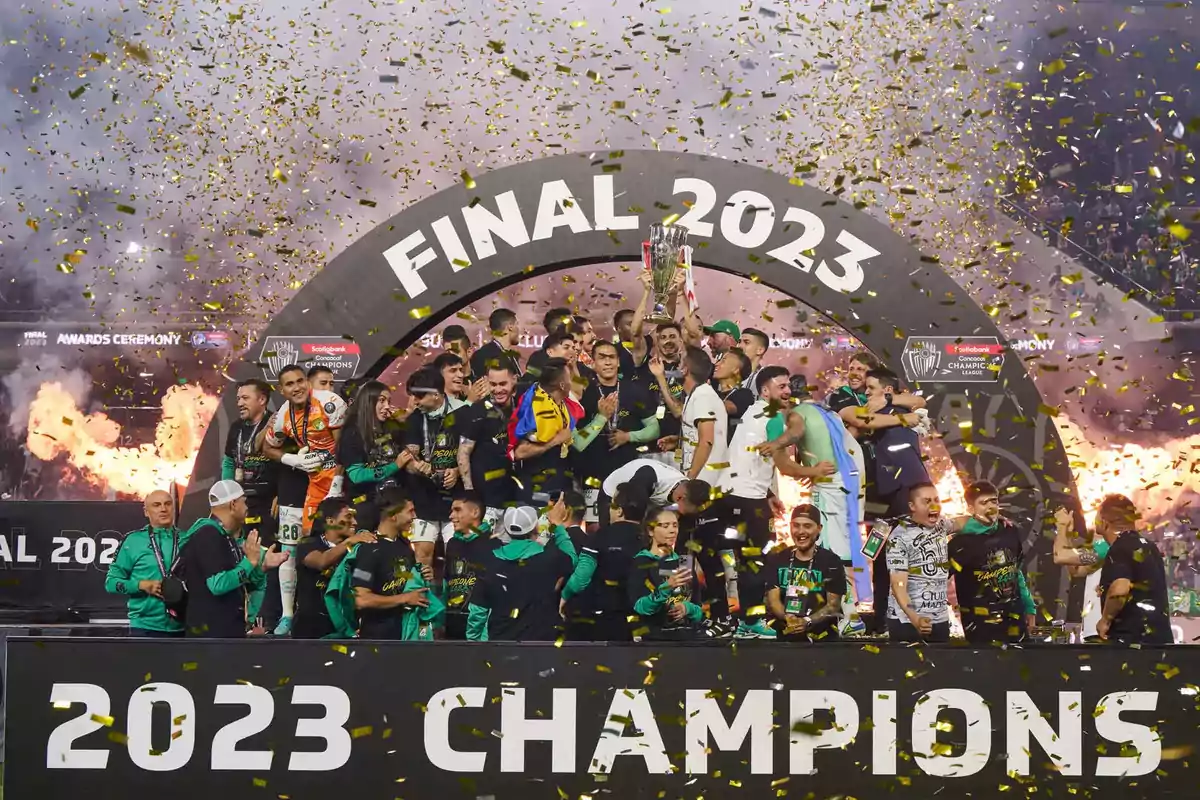 A soccer team celebrates their victory in the 2023 final with golden confetti falling and fireworks in the background as they lift the trophy on stage. A soccer team celebrates their victory in the 2023 final with golden confetti falling and fireworks in the background as they lift the trophy on stage.