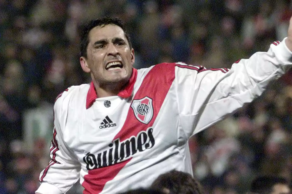 A player wearing the River Plate jersey celebrates on the field. A player wearing the River Plate jersey celebrates on the field.