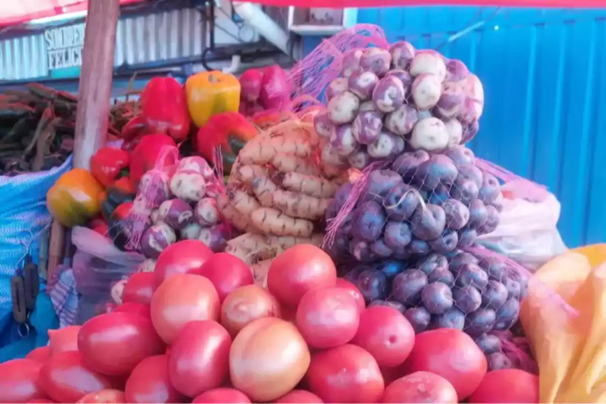 Fresh vegetables and Andean potatoes displayed at a market stall Fresh vegetables and Andean potatoes displayed at a market stall