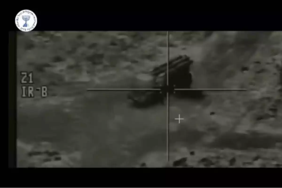 Black and white image of a military vehicle seen through a thermal camera sight with a logo in the upper left corner. Black and white image of a military vehicle seen through a thermal camera sight with a logo in the upper left corner.