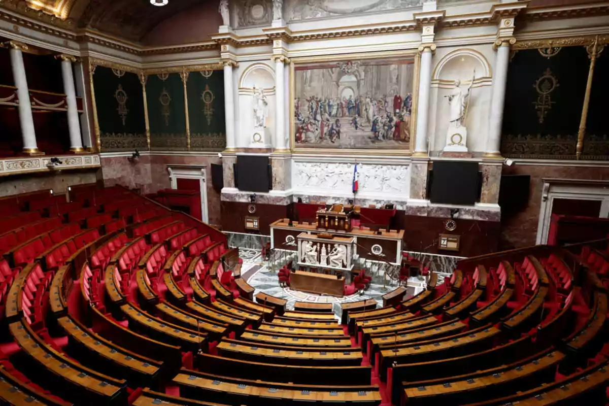 Elegant parliamentary chamber with red seats arranged in a semicircle and a large decorative painting on the front wall Elegant parliamentary chamber with red seats arranged in a semicircle and a large decorative painting on the front wall