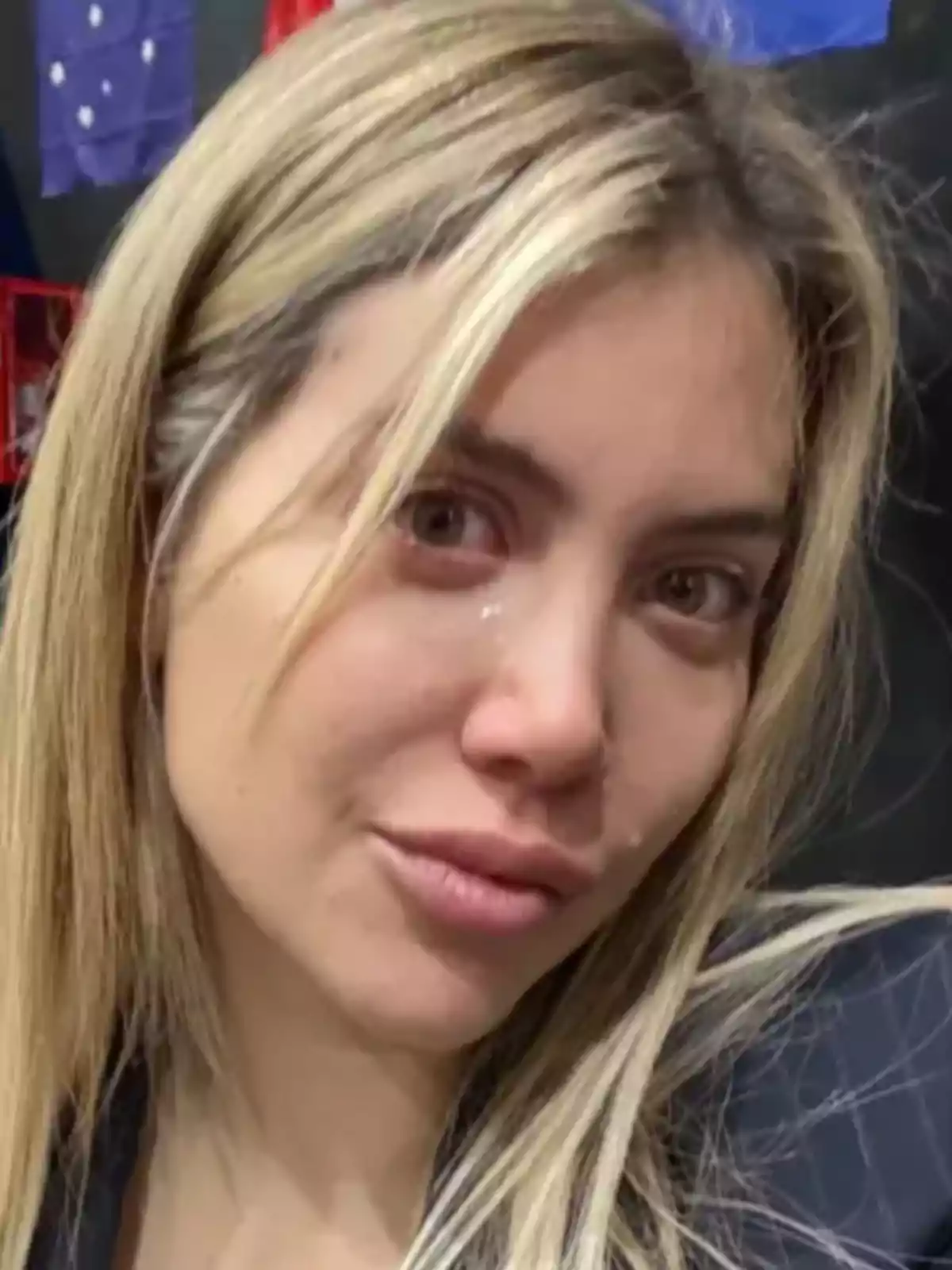 Blonde-haired woman with a serious expression and tears on her face Blonde-haired woman with a serious expression and tears on her face