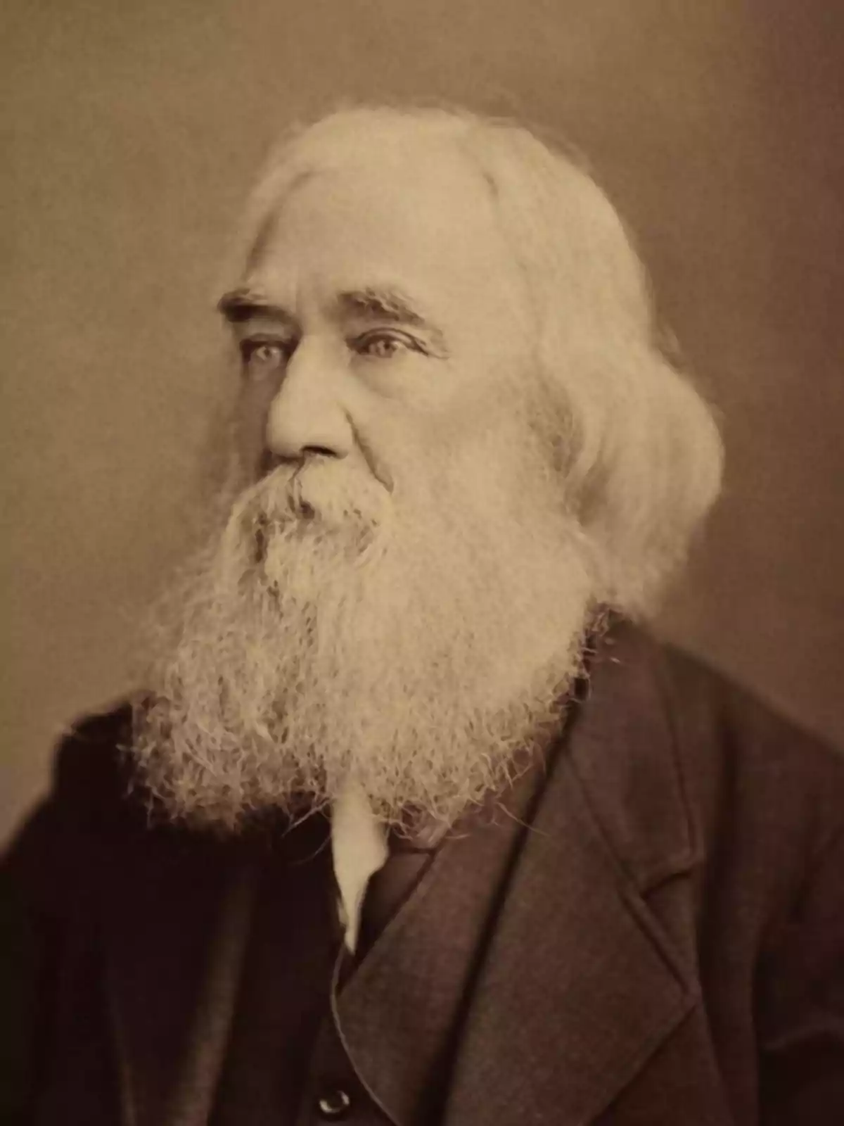 Old sepia portrait of an elderly man with a long gray beard and hair, dressed in a dark jacket and light jersey Old sepia portrait of an elderly man with a long gray beard and hair, dressed in a dark jacket and light jersey