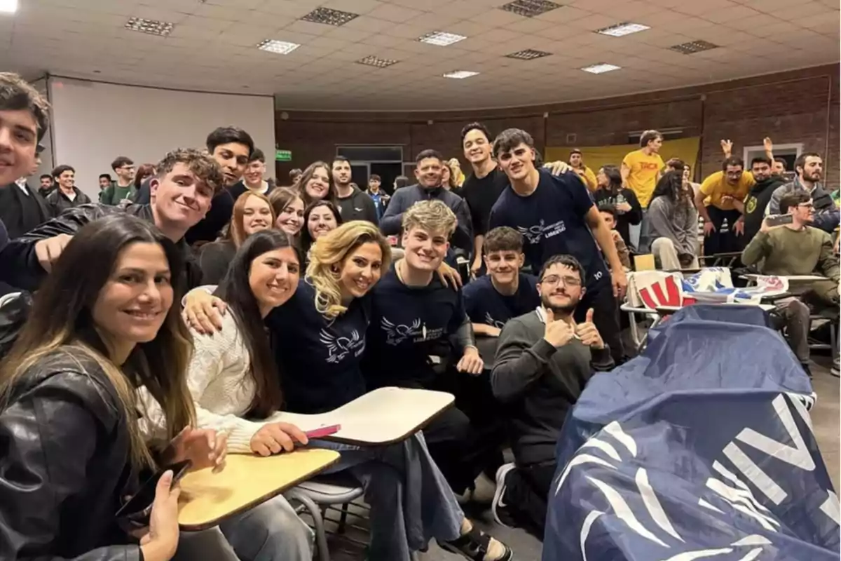 Group of smiling young people posing together in a classroom during a college event Group of smiling young people posing together in a classroom during a college event
