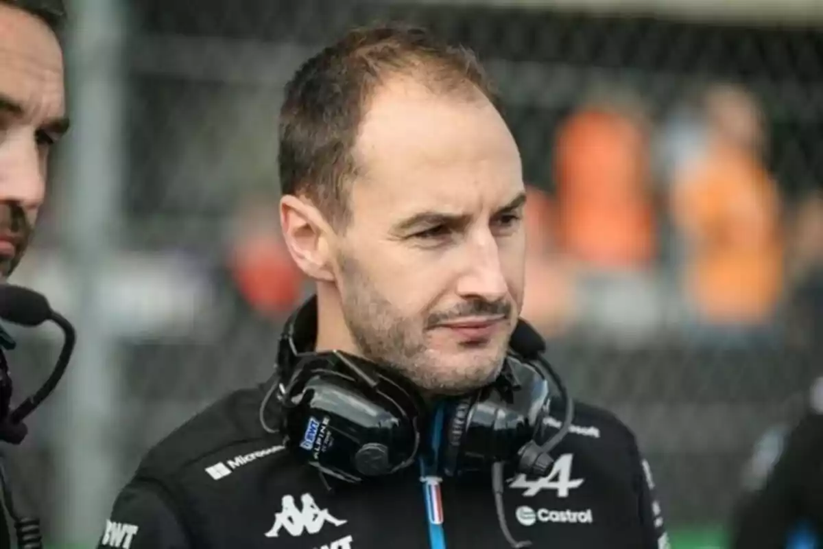 A man with headphones around his neck in an outdoor setting. A man with headphones around his neck in an outdoor setting.