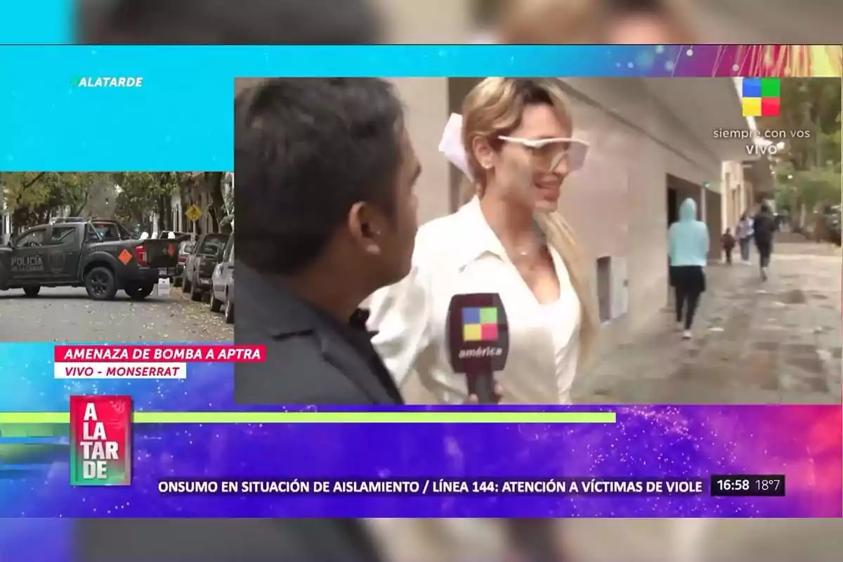 A reporter from América TV interviews a woman on the street while an image of a police vehicle and text indicating a bomb threat in Monserrat is shown in the upper left corner. A reporter from América TV interviews a woman on the street while an image of a police vehicle and text indicating a bomb threat in Monserrat is shown in the upper left corner.