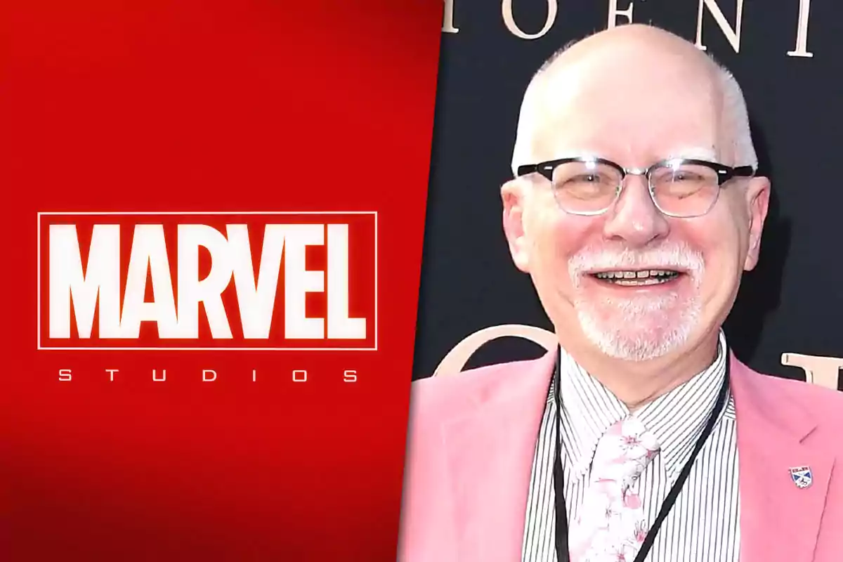 Smiling older man with glasses and a white beard wearing a pink jacket next to the Marvel Studios logo on a red background