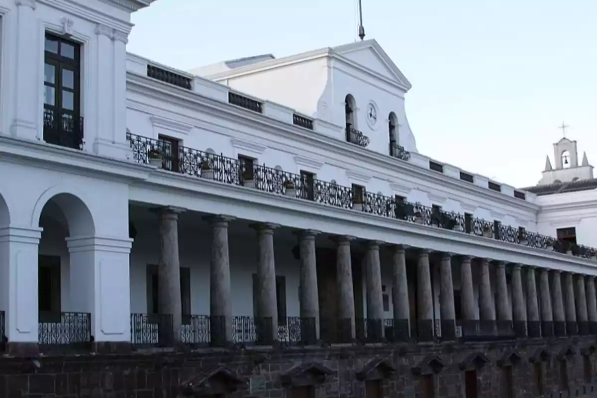 Historic building with columns and wrought iron balconies.